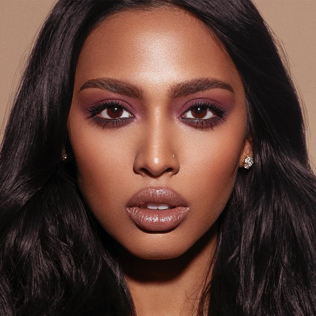 This is a model with purple eyeshadow and colorfix matte chocolate shade on her lips and under eyes.