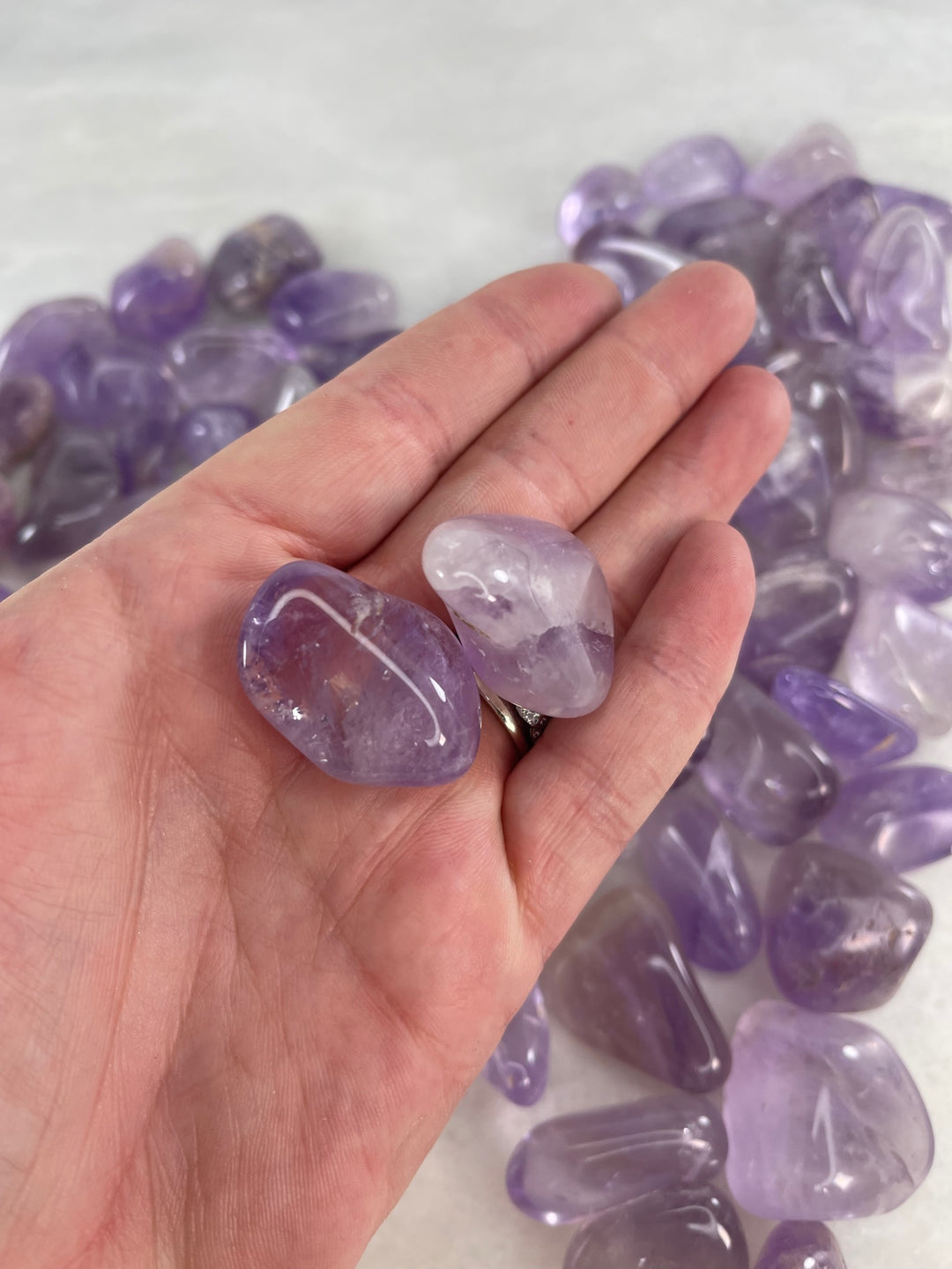 Light Amethyst Tumblers in the palm of a hand