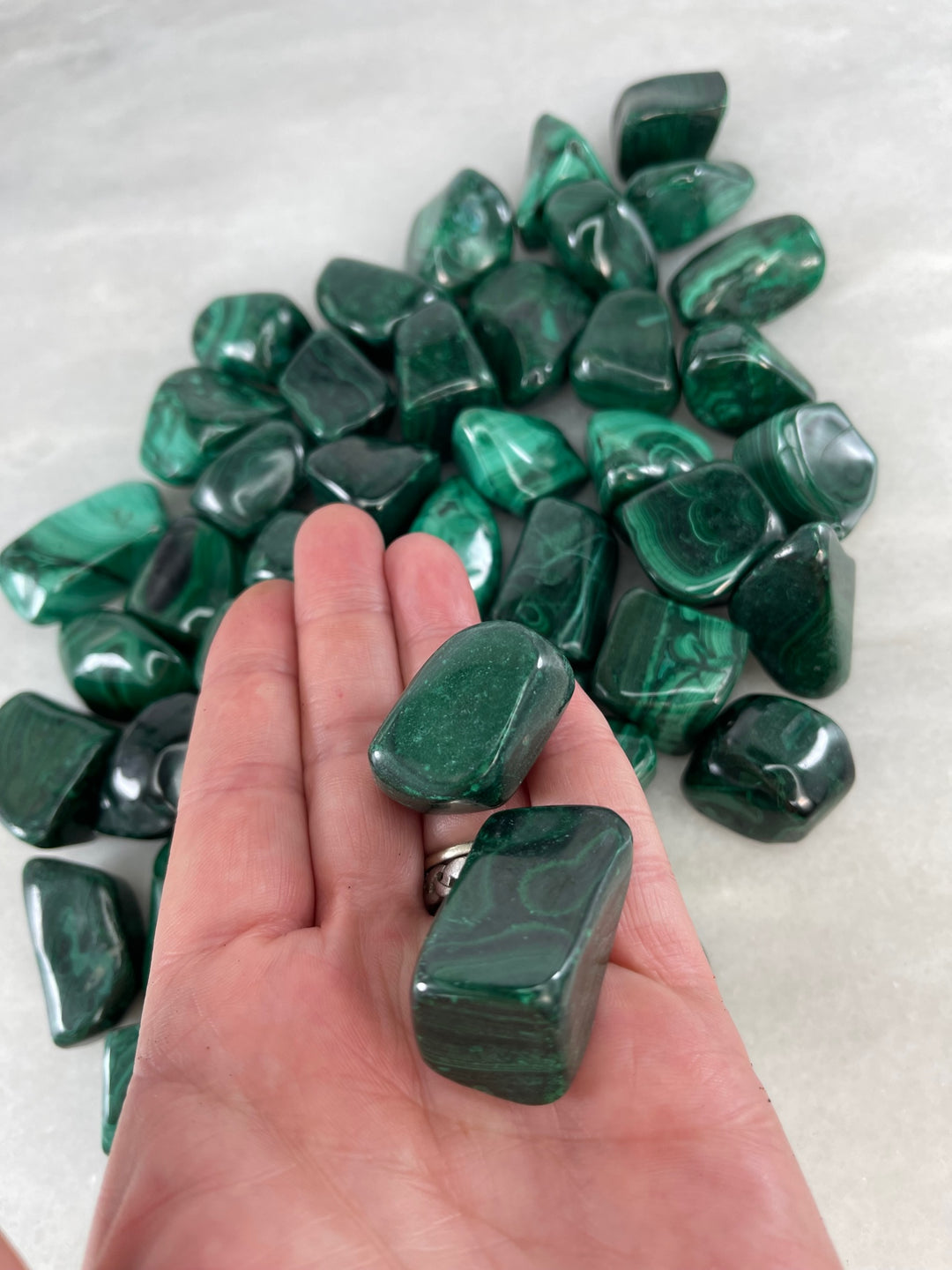 Malachite Tumblers in the palm of a hand
