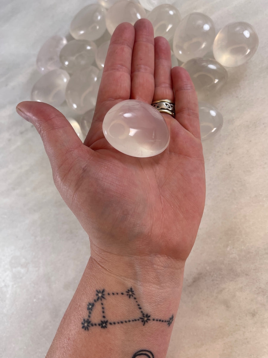 Pearl Quartz Palm Stone in the palm of a hand