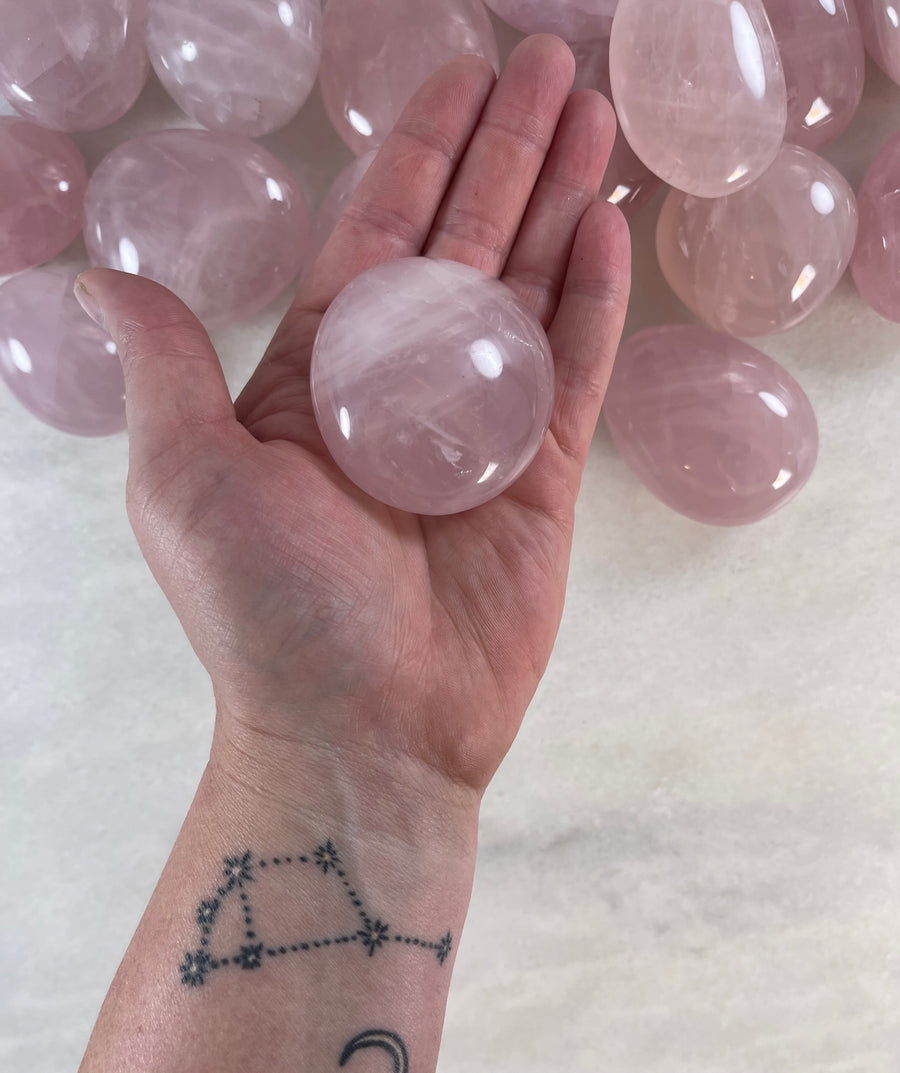 Rose Quartz Palm Stone in the palm of the hand 