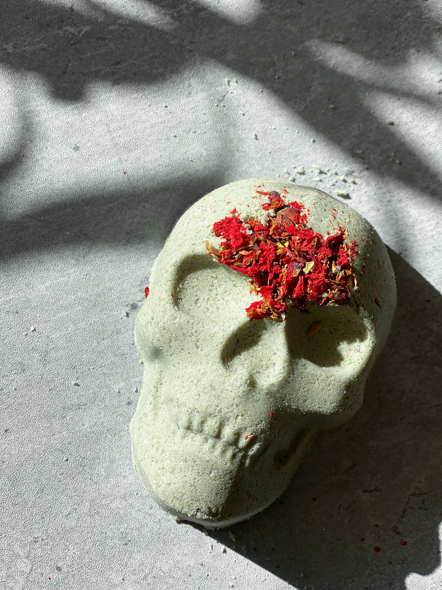 A skull white bath bomb with broken bloodstone inside