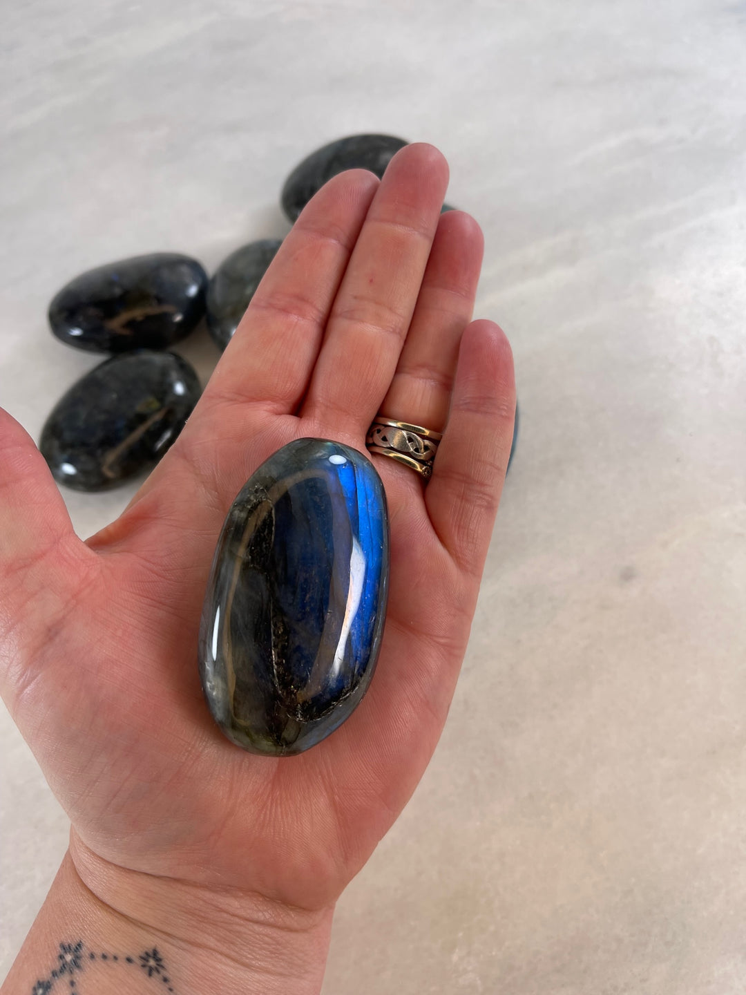 Labradorite Palm Stone in the palm of a hand