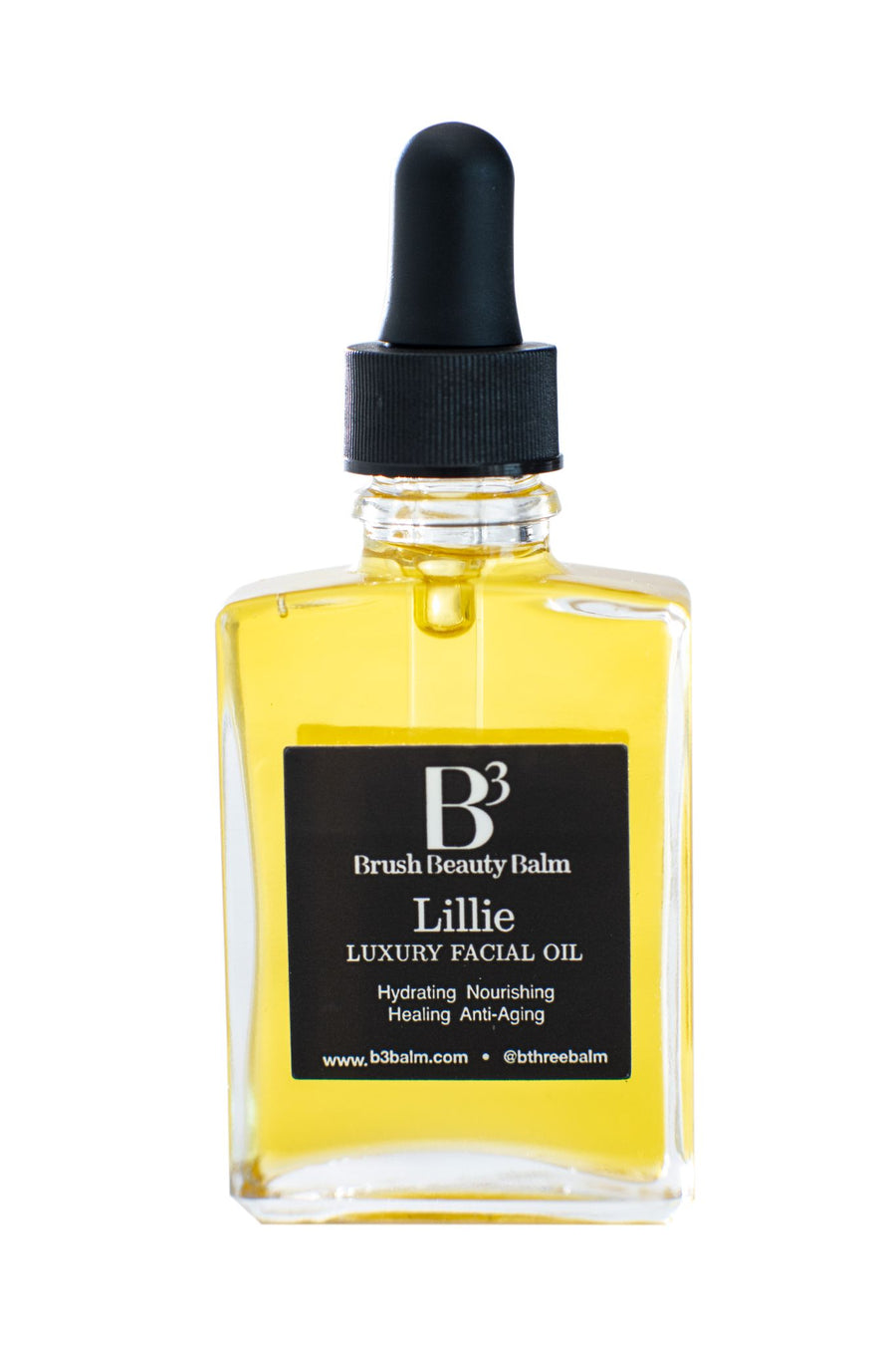 Bottle of the Lillie facial oil showing the clear glass bottle that has a clear glass dropper with rubber lid. Black and white label with product uses.